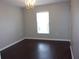 Bright dining room with chandelier and dark floors at 5337 Treig Ln, Wesley Chapel, FL 33545