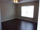 Spacious living room with dark wood floors and window at 5337 Treig Ln, Wesley Chapel, FL 33545