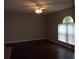 Living room boasting dark hardwood floors and an arched window at 5337 Treig Ln, Wesley Chapel, FL 33545