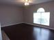 Living room with dark hardwood floors and a large window at 5337 Treig Ln, Wesley Chapel, FL 33545