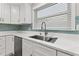 Modern kitchen sink and faucet with white cabinets and quartz countertops at 623 15Th Nw Ave, Largo, FL 33770