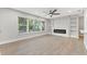 Living room with fireplace, hardwood floors and built-in shelving at 623 15Th Nw Ave, Largo, FL 33770