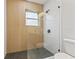 Modern shower with hexagon floor tiles and wood wall at 623 15Th Nw Ave, Largo, FL 33770