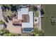 Aerial view of waterfront home with pool, dock, and unique architecture, located along the water's edge at 1840 Venetian Point Dr, Clearwater, FL 33755