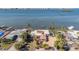 Waterfront home with lush trees, private dock, screened pool, and city views across a wide bay at 1840 Venetian Point Dr, Clearwater, FL 33755