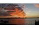 Spectacular waterfront view overlooking a body of water with a colorful sunset backdrop on the horizon at 1840 Venetian Point Dr, Clearwater, FL 33755