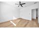 Spacious bedroom featuring light walls, wood-look floors, and a ceiling fan at 2608 W Columbus Dr # 3, Tampa, FL 33607