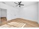 Bright bedroom with wood-look floors, ceiling fan, and door to hallway at 2608 W Columbus Dr # 3, Tampa, FL 33607