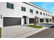 Modern townhome garages with black doors and landscaping at 2608 W Columbus Dr # 3, Tampa, FL 33607