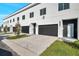 Modern townhome garages with black doors and landscaping at 2608 W Columbus Dr # 3, Tampa, FL 33607