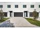 Attached garage with modern black doors and concrete driveway at 2608 W Columbus Dr # 3, Tampa, FL 33607