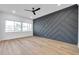 Spacious living room with dark gray geometric accent wall and hardwood floors at 2608 W Columbus Dr # 3, Tampa, FL 33607