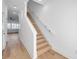 Modern light wood staircase with white railings and walls at 2608 W Columbus Dr # 3, Tampa, FL 33607