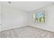 Simple bedroom with gray carpet and a large window at 9458 Shorebird Ct, Parrish, FL 34219