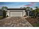 House exterior featuring a paved driveway and landscaping at 9458 Shorebird Ct, Parrish, FL 34219