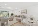 Bright living room with a neutral color palette, wood floors, and access to outdoor living space at 9458 Shorebird Ct, Parrish, FL 34219