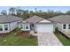 Beautiful home exterior with gray siding and brick driveway at 11509 Waterway Dr, Parrish, FL 34219