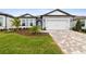 One-story home with gray siding, white garage door, and landscaped front yard at 11509 Waterway Dr, Parrish, FL 34219