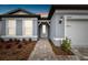 Gray house exterior, featuring a walkway and landscaping at 11509 Waterway Dr, Parrish, FL 34219