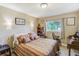 Cozy bedroom with hardwood floors and natural lighting featuring an antique desk area and charming decor throughout at 164 23Rd Sw Ave, Largo, FL 33778