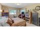 Comfortable bedroom with hardwood floors, lots of natural light, and a desk area with antique bookshelves and decor at 164 23Rd Sw Ave, Largo, FL 33778