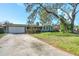 Charming home featuring a well-manicured lawn, mature trees, and a two-car garage at 164 23Rd Sw Ave, Largo, FL 33778