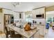 Modern kitchen featuring white cabinetry, granite countertops, stainless steel appliances, and an island with bar seating at 164 23Rd Sw Ave, Largo, FL 33778