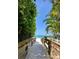 Wooden boardwalk leads to pristine beach under blue sky at 105 162Nd Ave, Redington Beach, FL 33708