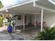 Home features carport with covered parking & seating area at 105 162Nd Ave, Redington Beach, FL 33708