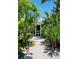 Inviting entryway to charming home, lush tropical landscaping at 105 162Nd Ave, Redington Beach, FL 33708