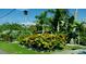 Landscaped yard with tropical plants and a manicured lawn at 105 162Nd Ave, Redington Beach, FL 33708