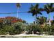 Mature palms and vibrant flowers enhance curb appeal at 105 162Nd Ave, Redington Beach, FL 33708