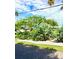 Mature tropical landscaping with palm trees & lush foliage at 105 162Nd Ave, Redington Beach, FL 33708