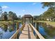 Wooden dock with gazebo providing scenic pond access at 2671 Sabal Springs Cir # 102, Clearwater, FL 33761