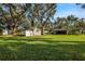 Large backyard with shed and mature trees at 3110 Camphor Dr, Plant City, FL 33566