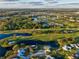 Aerial view of homes, golf course, and lakes in a Florida community at 1923 Sterling Glen Ct, Sun City Center, FL 33573