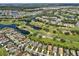 Aerial view of community with golf course and lake at 1923 Sterling Glen Ct, Sun City Center, FL 33573