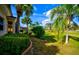 Landscaped backyard with lush greenery and golf course view at 1923 Sterling Glen Ct, Sun City Center, FL 33573