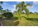 Landscaped backyard with lush tropical plants and golf course view at 1923 Sterling Glen Ct, Sun City Center, FL 33573