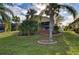 Back exterior view of house with landscaping and screened patio at 1923 Sterling Glen Ct, Sun City Center, FL 33573