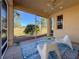 Relaxing screened patio with seating area and view of the golf course at 1923 Sterling Glen Ct, Sun City Center, FL 33573