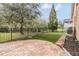 Landscaped backyard with artificial turf and patio at 19230 Climbing Aster Dr, Tampa, FL 33647