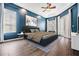 Serene bedroom with blue walls and hardwood floors at 19230 Climbing Aster Dr, Tampa, FL 33647