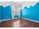 Cheerful bedroom with blue walls and wood flooring at 19230 Climbing Aster Dr, Tampa, FL 33647