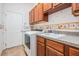 Laundry room with washer, dryer, and cabinets at 19230 Climbing Aster Dr, Tampa, FL 33647