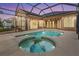 Enclosed pool and spa area with string lights at 19230 Climbing Aster Dr, Tampa, FL 33647