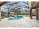 Enclosed pool and spa area with string lights at 19230 Climbing Aster Dr, Tampa, FL 33647