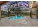 Enclosed pool and spa area with string lights at 19230 Climbing Aster Dr, Tampa, FL 33647