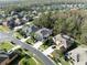 Aerial view showcasing home's location in a tree-lined neighborhood at 3405 Loggerhead Way, Wesley Chapel, FL 33544