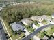 Aerial view showcasing home's location in a tree-lined neighborhood at 3405 Loggerhead Way, Wesley Chapel, FL 33544